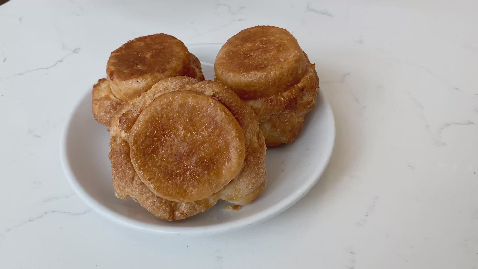 Video of DKA  (Dominique's Kouign Amann) which features a crispy, caramelized crust on the outside with a flaky and tender crumb within