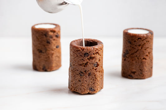 Milk being poured into chocolate chip cookie shots by Dominique Ansel